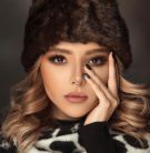 Woman Wearing Brown Fur Beanies and White and Balck Top