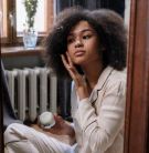 A woman putting on skin care